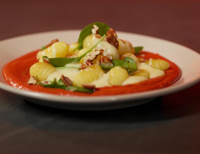 Gnocchis dorés, sauce Mont d’Or, crème de carottes violettes, épinards et noix de pécan